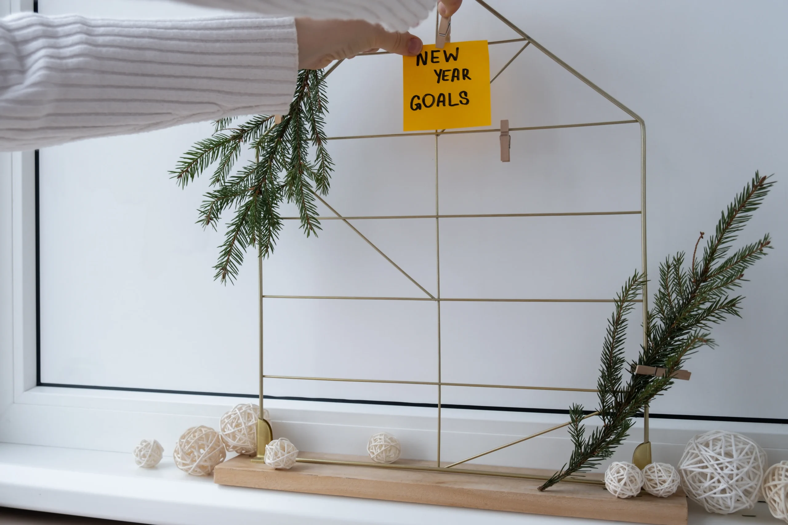 Woman creating an action board of new year's resolutions using colourful sticky notes.