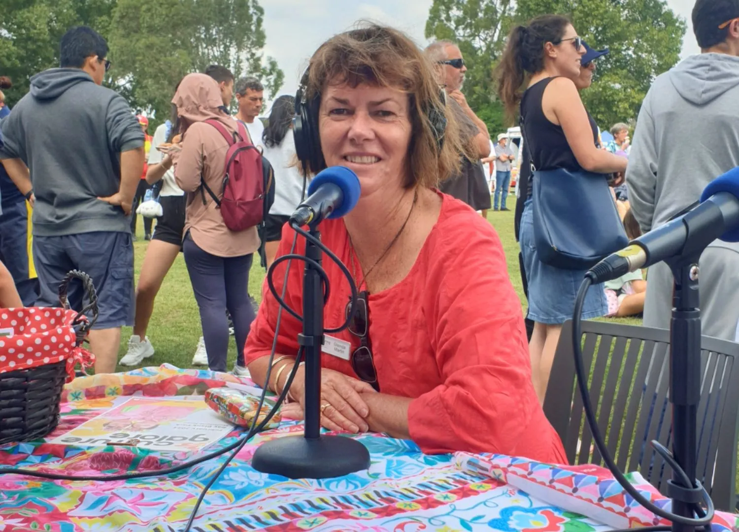 Outreach Manager Glenda speaking on a microphone for a PlainsFM Live Stream at the Culture Galore Festival.