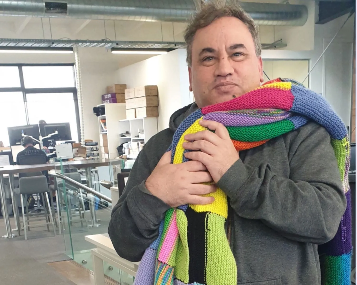 A staff member from Qtopia with their Knit for Purpose blankets